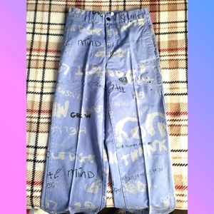 Purple wide pants with writing all over